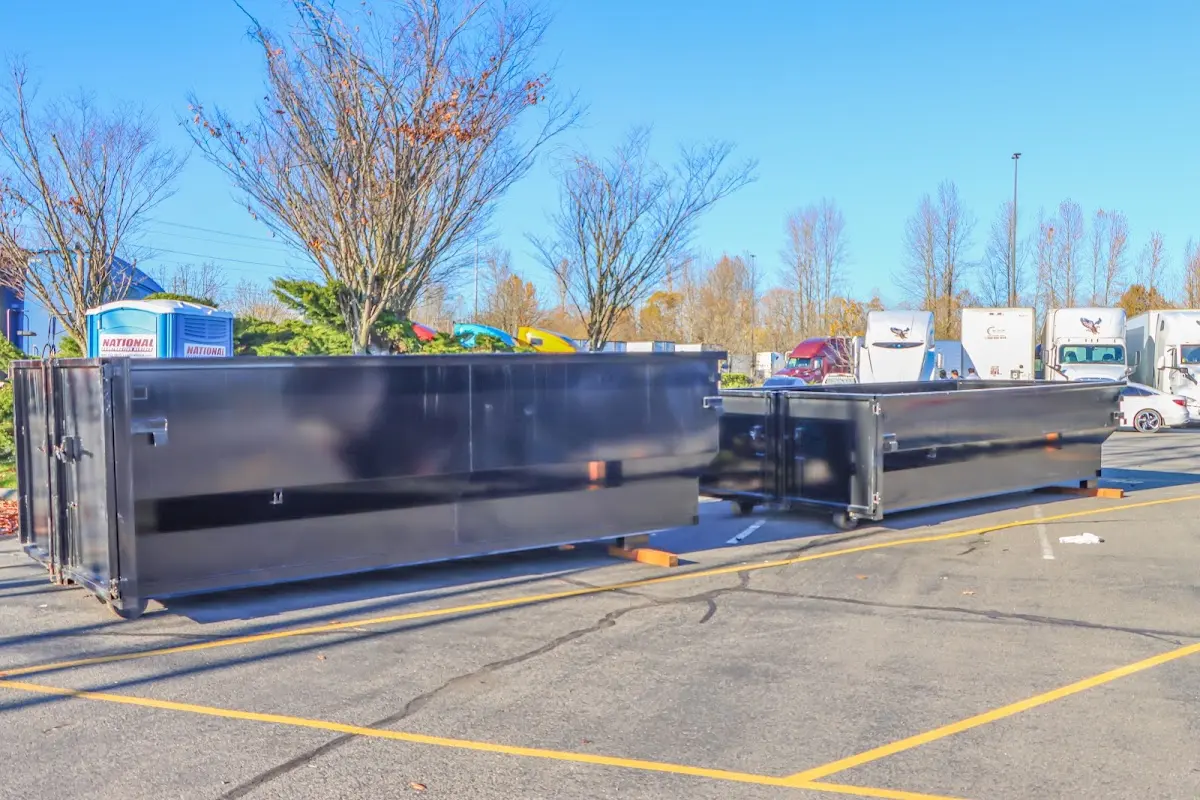 Professional dumpster rental service with roll-off container on residential driveway in Country Club Estates